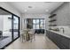 Modern bar area featuring sleek cabinetry, stylish geometric accent wall, and seamless indoor-outdoor access at 8520 E Cactus Wren Rd, Scottsdale, AZ 85250