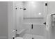 Modern bathroom with a glass-enclosed shower featuring white subway tiles, a built-in bench, and sleek black fixtures at 8520 E Cactus Wren Rd, Scottsdale, AZ 85250