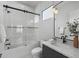 Contemporary bathroom with black hardware, white tile, and a glass-enclosed shower at 8520 E Cactus Wren Rd, Scottsdale, AZ 85250