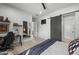 Cozy bedroom showcasing modern decor, wood floors, and a sliding barn door at 8520 E Cactus Wren Rd, Scottsdale, AZ 85250
