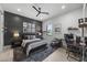 Comfortable bedroom with sports decor, a modern desk, and neutral color scheme with grey accent wall at 8520 E Cactus Wren Rd, Scottsdale, AZ 85250