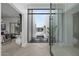 Bright foyer with modern design, herringbone wood floors, and a view of the outdoor courtyard at 8520 E Cactus Wren Rd, Scottsdale, AZ 85250