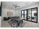 Bright game room featuring a ping pong table, comfortable seating, and sliding glass doors to the backyard at 8520 E Cactus Wren Rd, Scottsdale, AZ 85250