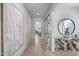 Bright hallway with light wood floors, a decorative console table, and an abstract art piece at 8520 E Cactus Wren Rd, Scottsdale, AZ 85250