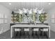 Kitchen with a large island, bar seating, and unique decorative backsplash with open shelving at 8520 E Cactus Wren Rd, Scottsdale, AZ 85250