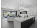 Open-concept kitchen with large island, modern lighting, and seamless flow to the outdoor patio at 8520 E Cactus Wren Rd, Scottsdale, AZ 85250