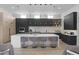Contemporary kitchen boasts a large island with seating, dark cabinets, and natural wood accents at 8520 E Cactus Wren Rd, Scottsdale, AZ 85250