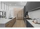 Gourmet kitchen features an island with a sink, stainless steel appliances, and modern cabinetry at 8520 E Cactus Wren Rd, Scottsdale, AZ 85250