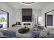 Sophisticated living room with a linear fireplace, modern chandelier, and large sliding glass doors at 8520 E Cactus Wren Rd, Scottsdale, AZ 85250