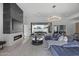 Open-concept living room featuring a fireplace, modern lighting, and outdoor access to patio at 8520 E Cactus Wren Rd, Scottsdale, AZ 85250