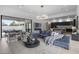 Open concept living room featuring a comfortable blue sectional sofa and elegant lighting fixture at 8520 E Cactus Wren Rd, Scottsdale, AZ 85250