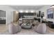 Stylish living area featuring modern chairs surrounding a unique round coffee table and kitchen views at 8520 E Cactus Wren Rd, Scottsdale, AZ 85250