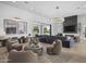 Bright open floorplan with statement lighting, fireplace feature wall, and modern gray sofas at 8520 E Cactus Wren Rd, Scottsdale, AZ 85250