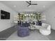 Living room features a stylish bar area, comfortable seating, and a large television at 8520 E Cactus Wren Rd, Scottsdale, AZ 85250
