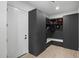Mud room featuring gray built-in cabinets and bench offering plenty of storage near the entry at 8520 E Cactus Wren Rd, Scottsdale, AZ 85250