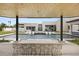 Under the pergola, a bar overlooks the pool offering a perfect vantage point for entertaining at 8520 E Cactus Wren Rd, Scottsdale, AZ 85250