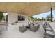 Outdoor kitchen and living space offers a grill, bar seating, and a covered lounge area at 8520 E Cactus Wren Rd, Scottsdale, AZ 85250