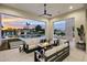 Inviting outdoor living space featuring a cozy fireplace and views of the luxurious pool and serene twilight sky at 8520 E Cactus Wren Rd, Scottsdale, AZ 85250