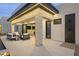 Covered patio with stone pillar, outdoor shower and plush seating offers luxurious outdoor living at 8520 E Cactus Wren Rd, Scottsdale, AZ 85250