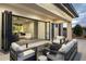 Spacious patio with comfortable seating and seamless indoor-outdoor flow through large sliding glass doors at 8520 E Cactus Wren Rd, Scottsdale, AZ 85250