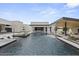 Expansive pool with umbrellas, lounge seating, water feature and views of the property at 8520 E Cactus Wren Rd, Scottsdale, AZ 85250