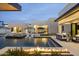 Resort-style pool features a spa, sun loungers, and fire features creating an inviting outdoor oasis at 8520 E Cactus Wren Rd, Scottsdale, AZ 85250