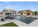 Luxury pool and outdoor living space features a water feature and lush desert landscaping at 8520 E Cactus Wren Rd, Scottsdale, AZ 85250