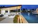 Backyard oasis featuring a large pool, spa, covered outdoor kitchen and living area with a linear fire feature at 8520 E Cactus Wren Rd, Scottsdale, AZ 85250