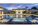 Luxurious pool features an integrated hot tub, poolside bar, and stylish umbrellas at 8520 E Cactus Wren Rd, Scottsdale, AZ 85250