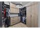 Custom walk-in closet with built-in shelving, drawers, and modern lighting for organized storage at 8520 E Cactus Wren Rd, Scottsdale, AZ 85250