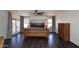 Well-lit bedroom with wood furniture, wood floors, and neutral walls and window coverings at 10628 W Country Club Trl, Peoria, AZ 85383