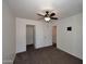 Bright bedroom features neutral paint, ceiling fan, and closet at 10628 W Country Club Trl, Peoria, AZ 85383