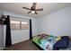 bedroom with light blue walls, window and Paw Patrol themed bedspread at 10628 W Country Club Trl, Peoria, AZ 85383