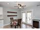 Cozy dining area featuring french doors to the back yard, floating shelves and a modern ceiling fan at 10628 W Country Club Trl, Peoria, AZ 85383