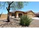 Well-maintained front yard with gravel, desert plants, and a charming fountain feature at 10628 W Country Club Trl, Peoria, AZ 85383