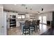 Kitchen with white cabinets, stainless steel appliances, kitchen island with bar seating and backyard access at 10628 W Country Club Trl, Peoria, AZ 85383