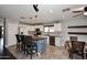 Bright kitchen with white cabinetry, stainless steel appliances, tile backsplash, and a dining area at 10628 W Country Club Trl, Peoria, AZ 85383
