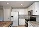 Bright kitchen with white cabinets, stainless steel appliances, and granite countertops at 10628 W Country Club Trl, Peoria, AZ 85383