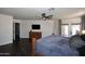 Primary bedroom with wood floors, neutral walls, ceiling fan, and direct access to the backyard at 10628 W Country Club Trl, Peoria, AZ 85383