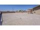 Expansive backyard with large lot of gravel, a brick wall, basketball court, and access to a covered patio at 10655 E Broadway Rd, Mesa, AZ 85208
