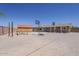 Spacious backyard features gravel throughout, a basketball court, shed, covered patio, and brick perimeter at 10655 E Broadway Rd, Mesa, AZ 85208