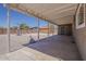 Expansive backyard under a covered patio, featuring a concrete foundation, gravel, brick wall, and basketball court at 10655 E Broadway Rd, Mesa, AZ 85208