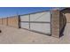 A large chain link gate is the point of access to the expansive backyard and gravel foundation at 10655 E Broadway Rd, Mesa, AZ 85208