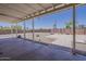 Expansive backyard under a covered patio, featuring a concrete foundation, gravel, brick wall, and basketball court at 10655 E Broadway Rd, Mesa, AZ 85208