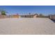Spacious backyard features gravel throughout, a basketball court, shed, covered patio, and brick perimeter at 10655 E Broadway Rd, Mesa, AZ 85208