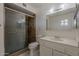 Modern bathroom with a glass-enclosed shower, sleek vanity, and a bright mirror at 10655 E Broadway Rd, Mesa, AZ 85208