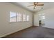 Bedroom featuring neutral carpet, ceiling fan, and two windows at 10655 E Broadway Rd, Mesa, AZ 85208