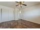 Bedroom with spacious closet, hardwood floors, and neutral walls at 10655 E Broadway Rd, Mesa, AZ 85208