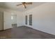 Bedroom featuring neutral carpet and white french doors to the exterior at 10655 E Broadway Rd, Mesa, AZ 85208