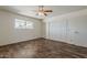 Bedroom features laminate floors, ceiling fan, and closet space at 10655 E Broadway Rd, Mesa, AZ 85208